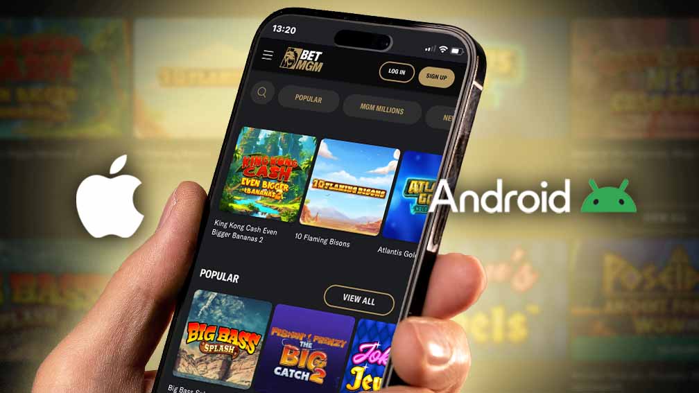 A hand holding a phone acessing the BetMGM app that is acessible in iOS and Android